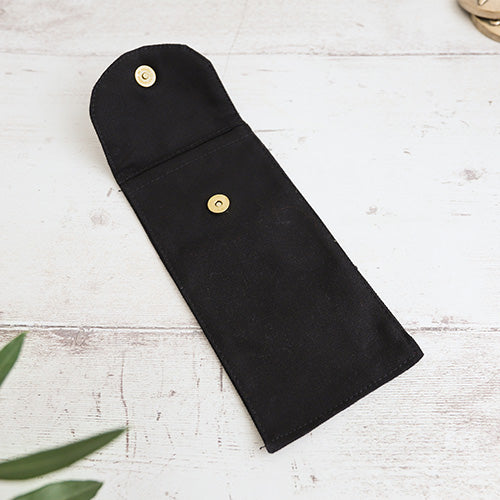 Open black cotton sleeve pouch with metal button fastener