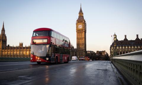 London Bus Driving Down Street with Big Ben in Background