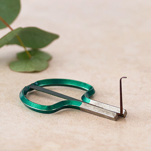 green metal jaw harp