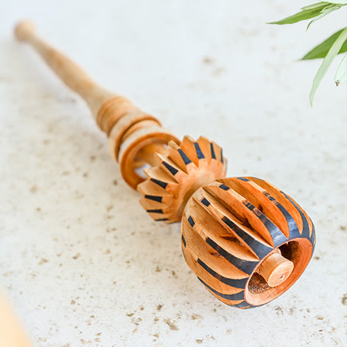 Molinillo whisk mechanism on a white background