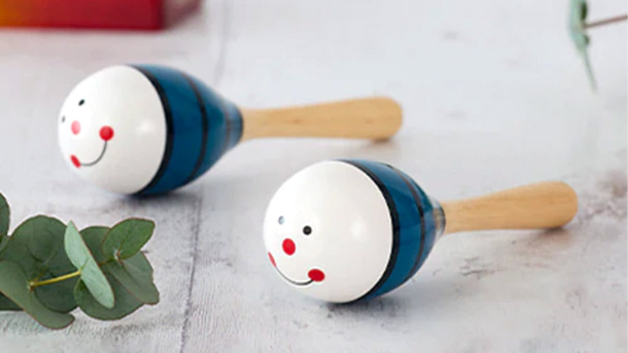 Wooden maraca shakers with happy face design
