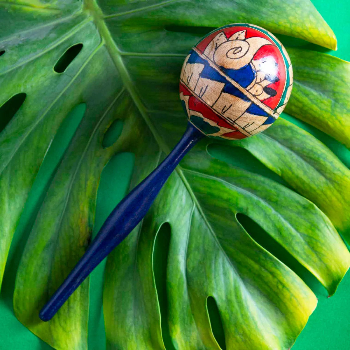 Large-headed egg shaker on a green background