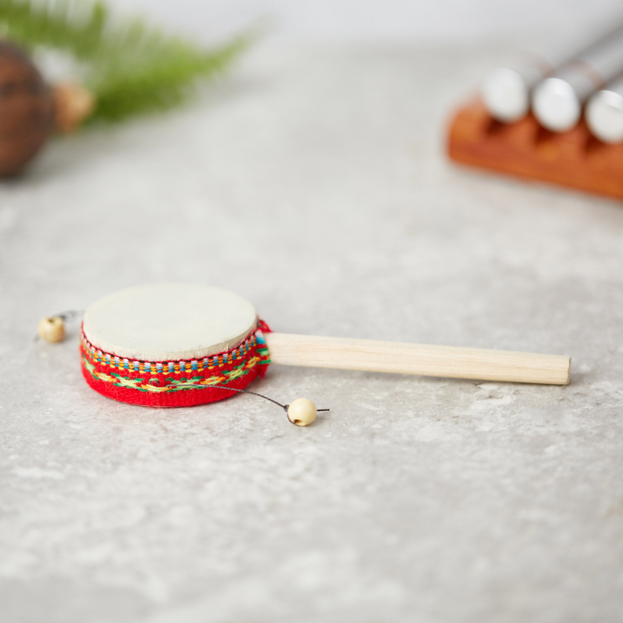 Small peruvian monkey twist drum with red ribbon